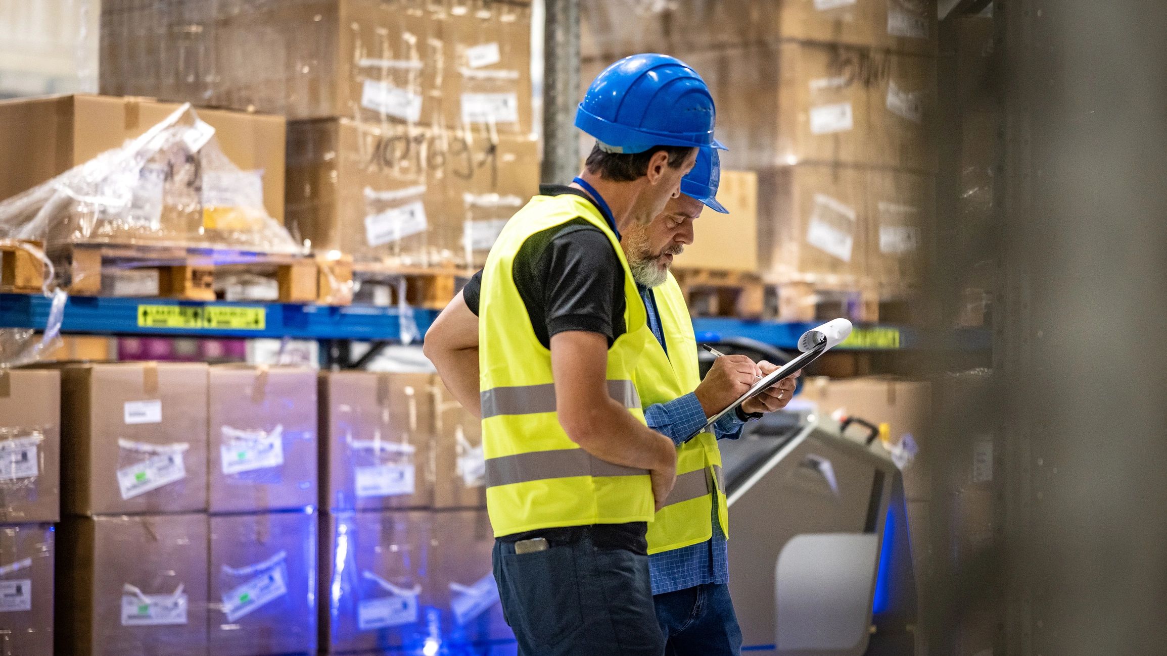 Industrial professionals reviewing equipment inventory together