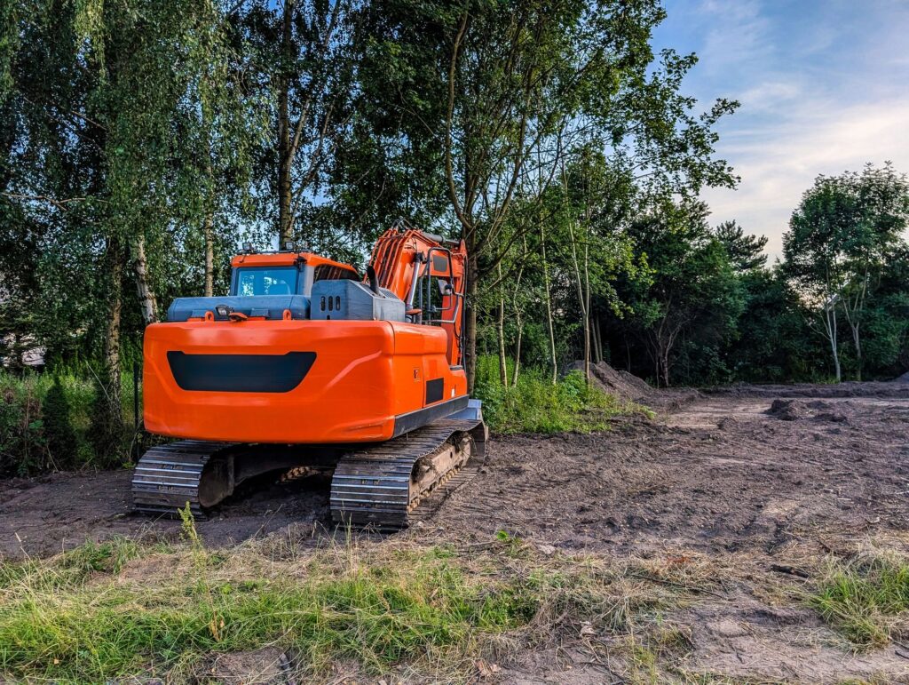 Orange Crawler Excavator Construction Site Heavy Machinery Earthmoving Equipment On Cleared Land Infrastructure